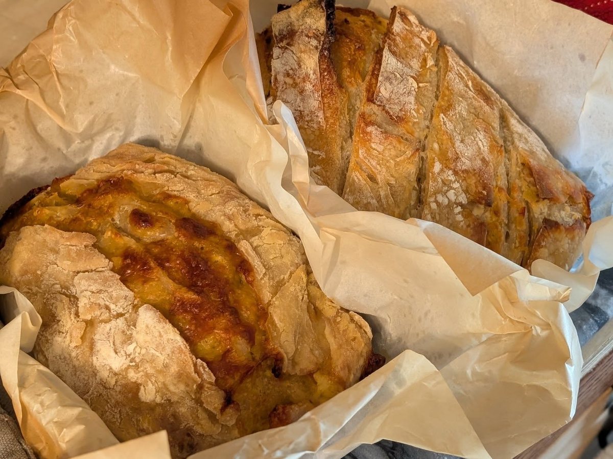 A group of golden rustic loaves cooling together
